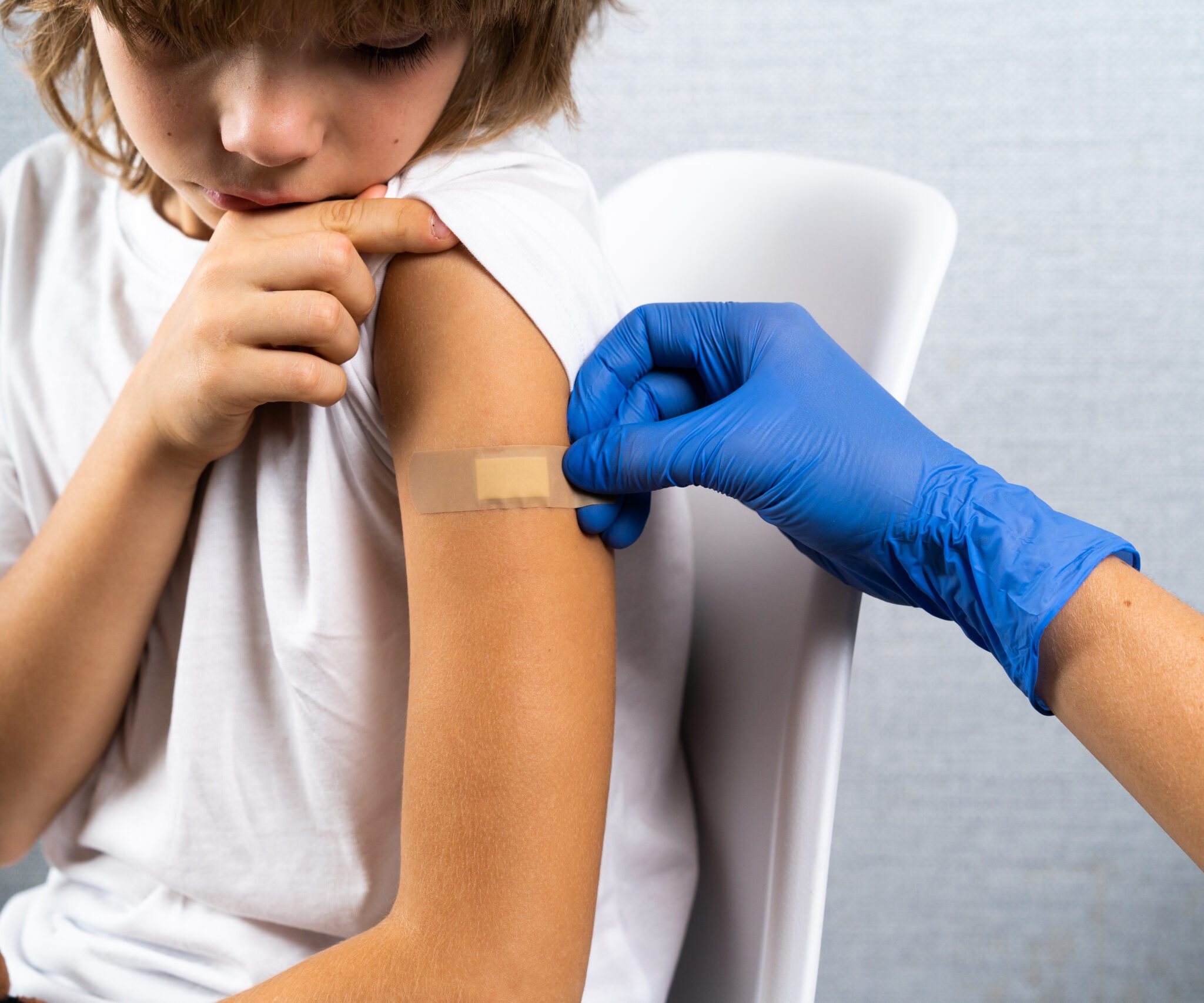 vaccination of children, a little boy at a doctor's appointment, an injection in the arm, children's medicine, an injection in the arm.